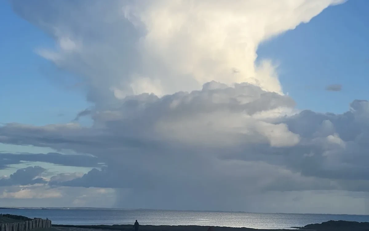 Towering cumulonimbus cloud rising over the Brittany coastline
